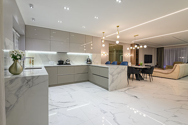 Luxury large modern white marble kitchen united with dining room and living room