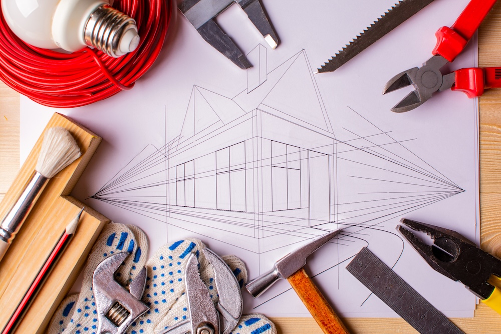 concept of home improvement. a set of tools and a drawing of the house