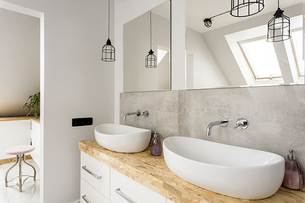 Minimalist bathroom with two sinks and wooden vanity top